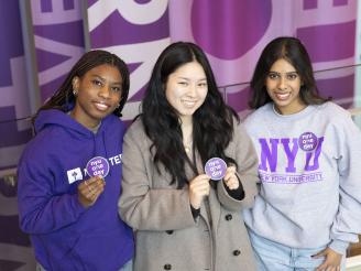 Students pose to support NYU One Day